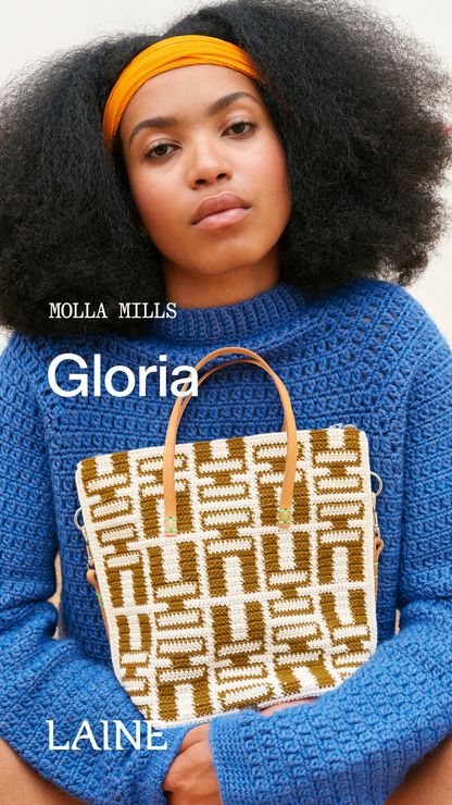 Woman holding a patterned Gloria handbag designed by Molla Mills 