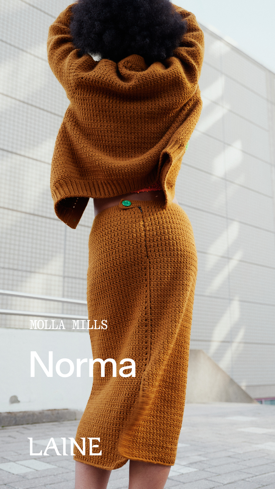 Person wearing a brown crochet cardigan and skirt set designed by Molla Mills