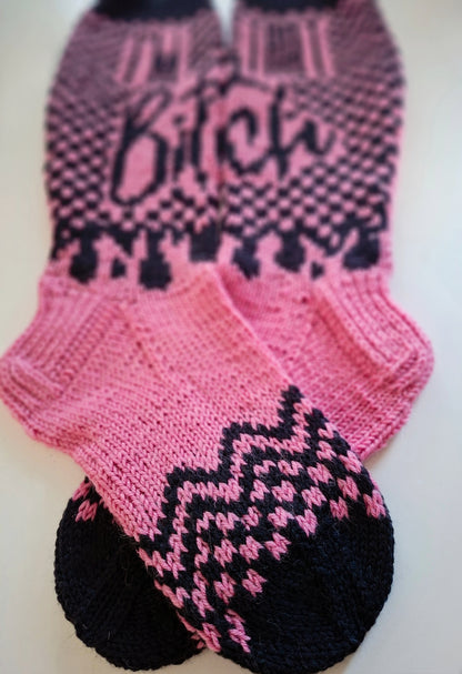 Pair of pink and black patterned socks on a white background